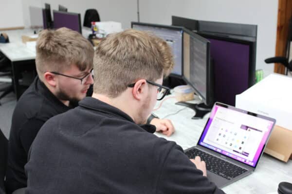 IT Technicians setting up a Macbook Pro