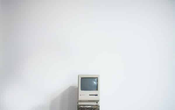 Old Macbook computer against a white background